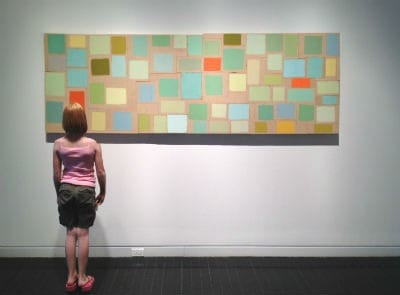 girl looking at painting