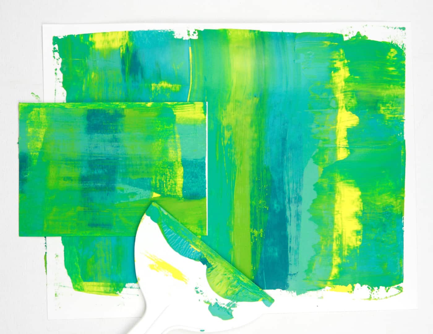 acrylic paint scraoped across paper in greens and yellows