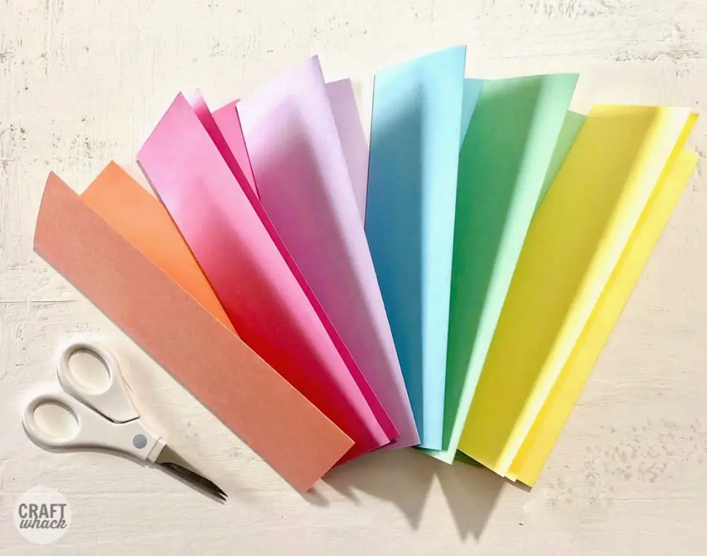 folded colored cardtsock and scissors for making a paper leaf wreath