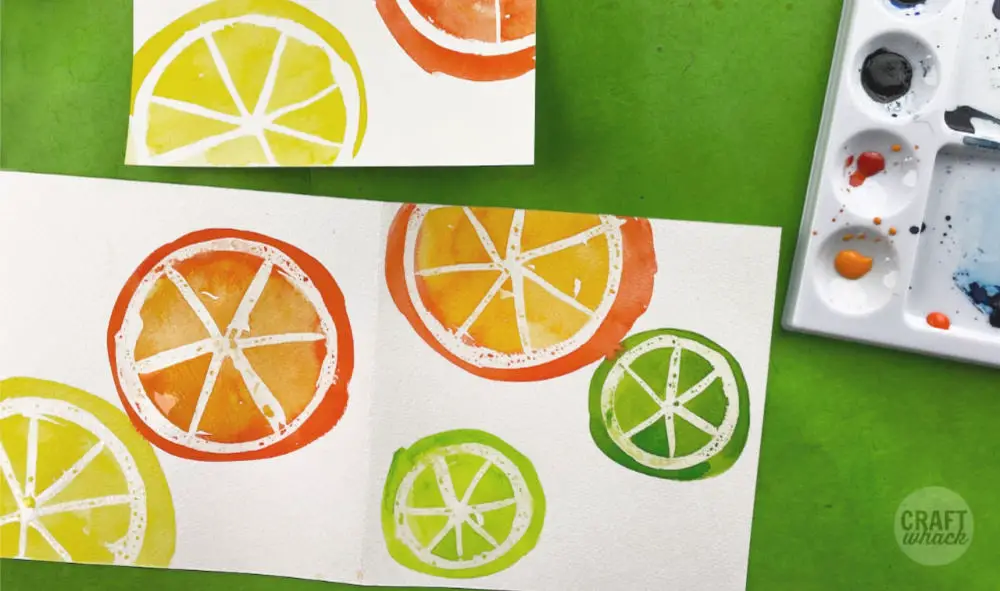 open watercolored cards of fruits