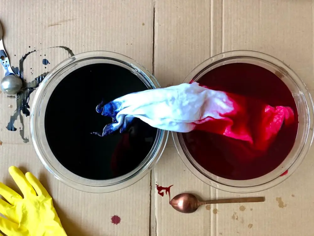 dip dying a t-shirt in red and blue dye for 4th of july