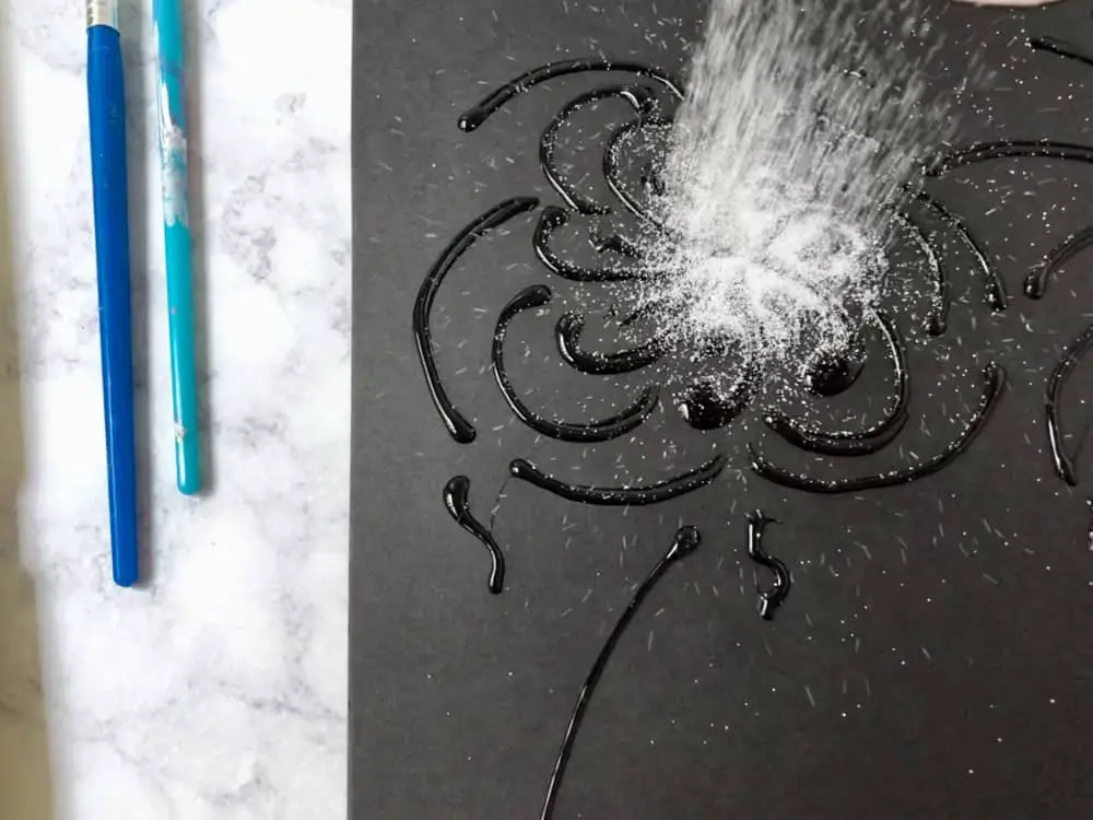 pouring salt on glue for salt painting